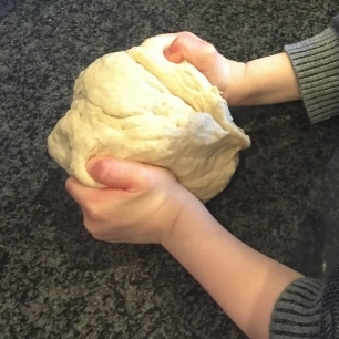 Emma's son kneading the flatbread dough