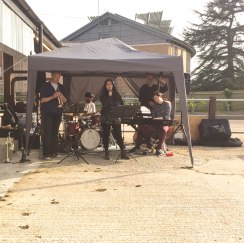 A photo of a band called Rcubed playing live music.
