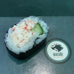 A close up photograph of a crabmeat and cucumber roll.