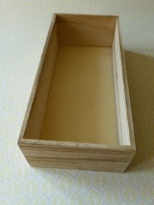 A photograph of the plain wooden box