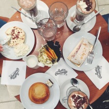 A top-down photograph of a table at Butler's Chocolate Cafe in Dublin. Emma and her two friends had hot chocolate and cake!