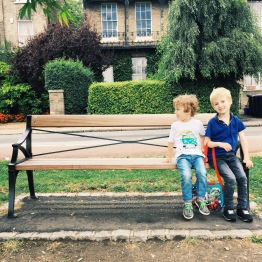 A photograph of Emma's children, Ben and Ollie, on a bench on Parker's Piece in Cambridge