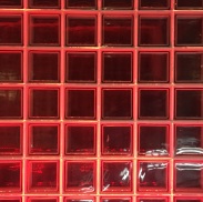 A photograph of a glass wall with red chequerboard pattern to demonstrate pattern and repetition. It was taken at the Guinness Storehouse in Dublin.