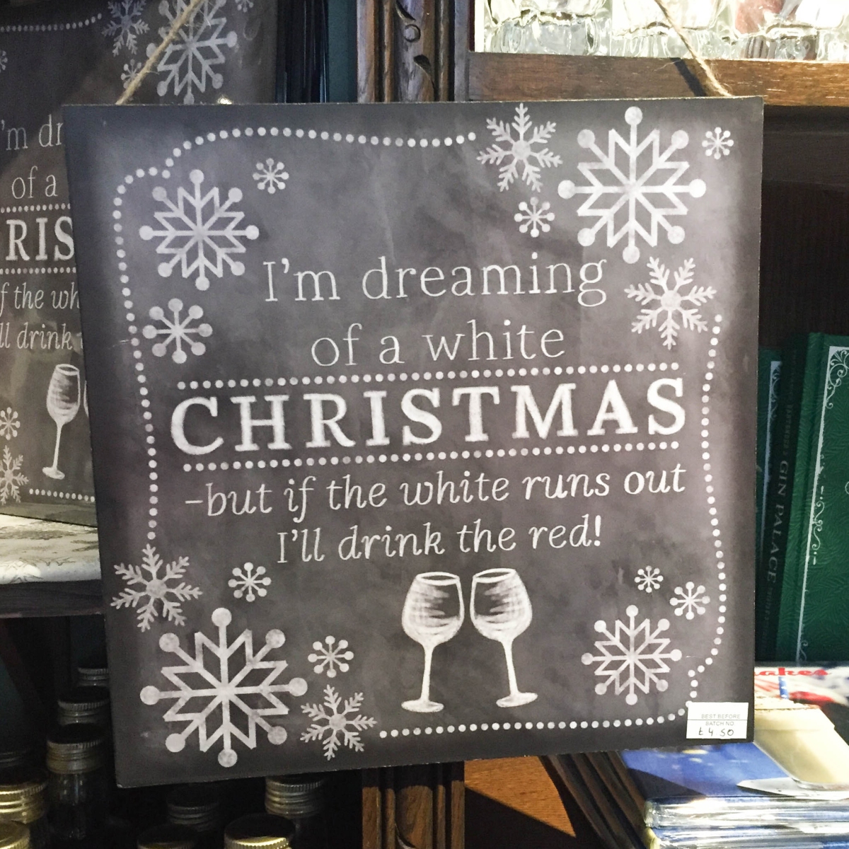 A photograph of a blackboard sign at Ely Gin saying, "I'm dreaming of a white Christmas, but if the white runs out I'll drink the red"