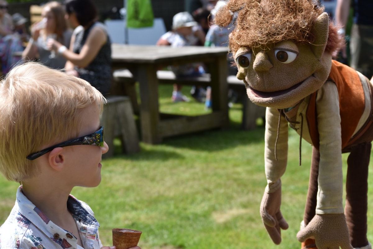 A photograph of Ollie meeting Swampy being held by a Twiggle.