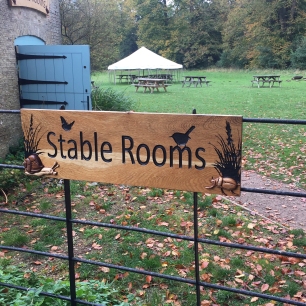 A photograph of a sign for the stable rooms.