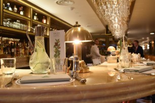 A photograph showing a close up of the table setting on the bar, each with its own lamp