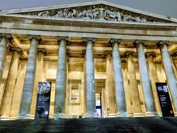The columned frontage of the British Museum lit at night